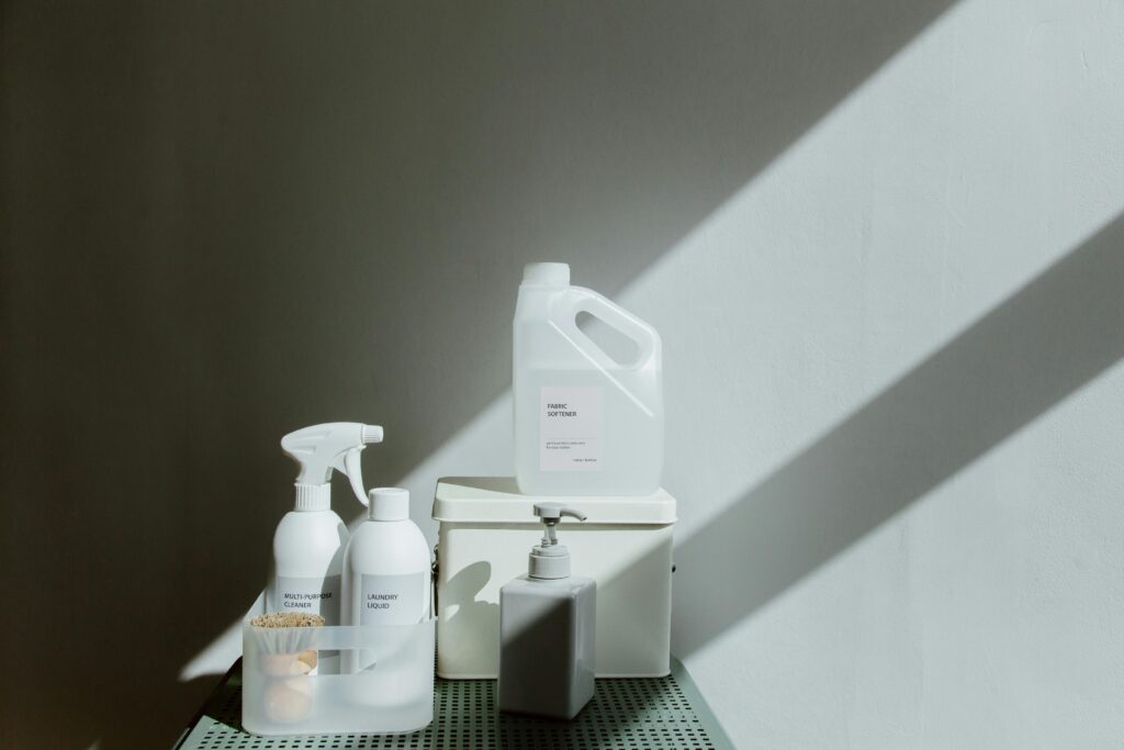 Safe & Effective Home & Office Cleaning Simple arrangement of cleaning products with dramatic lighting and shadows.