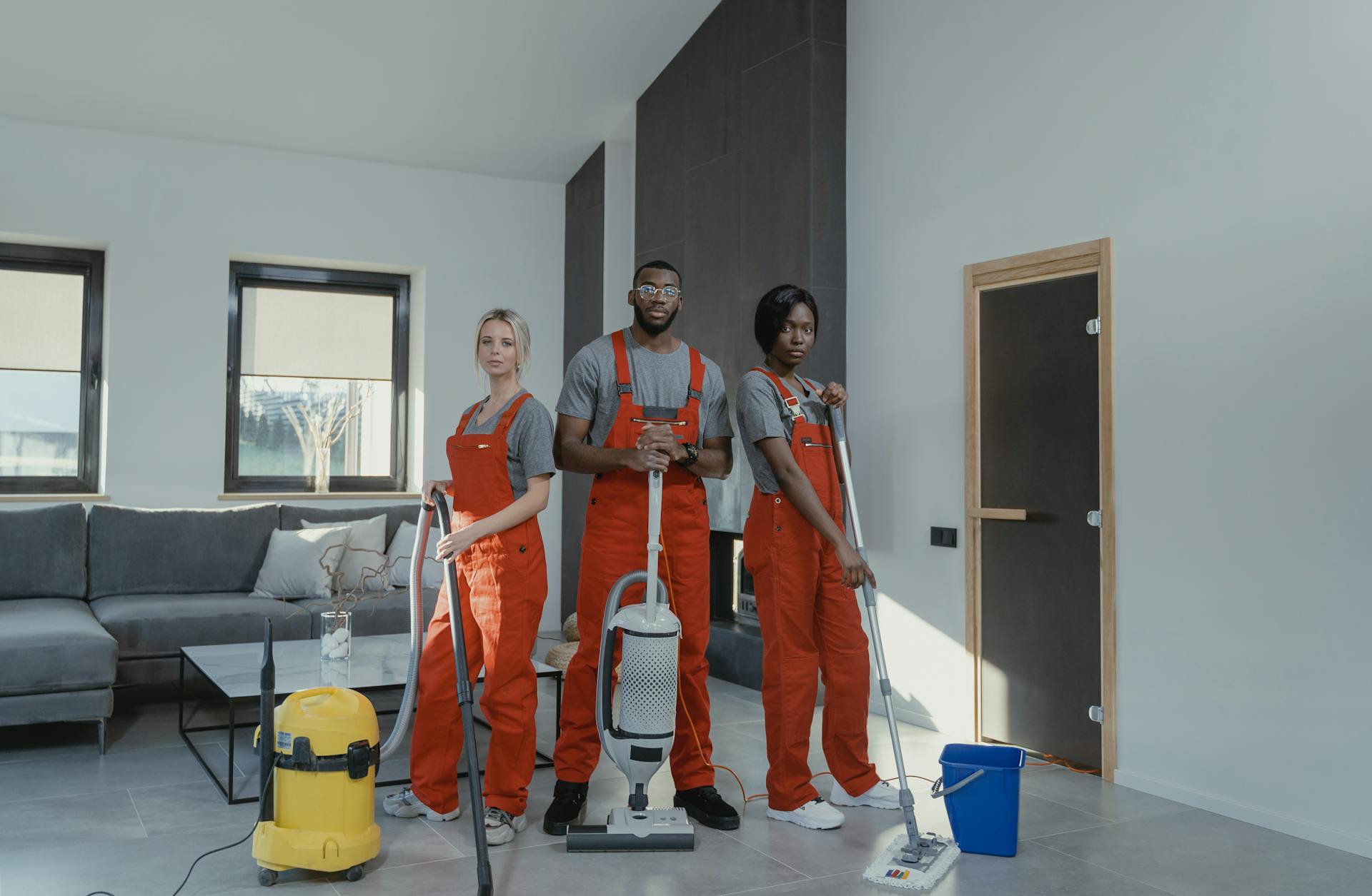 3 people are cleaning the home